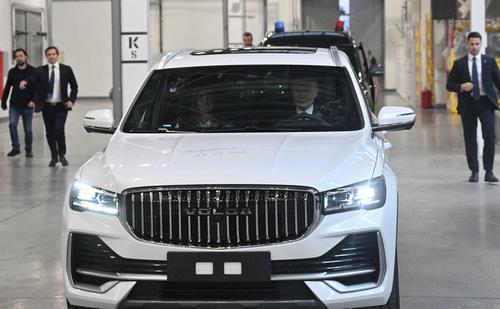 Vladimir Putin behind the wheel of a VOLGA K50 car