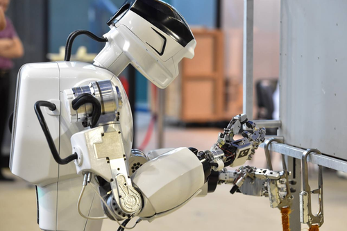 Anthropomorphic robot Marfa performs a task with a carabiner