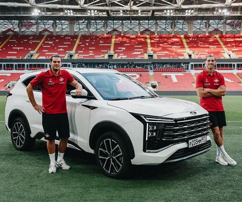 Football players against the background of the new Moskvich 8 car