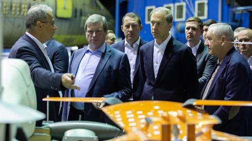 Denis Manturov, accompanied by Andrei Dutov, examines the presented samples