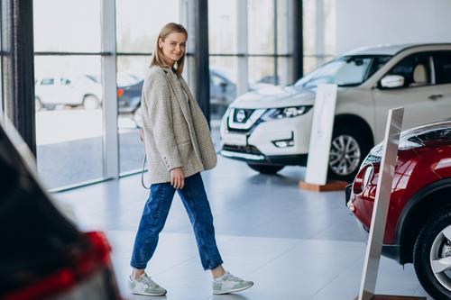 Girl in a car dealership