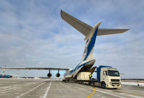 Il-76 cargo plane unloading containers with satellites