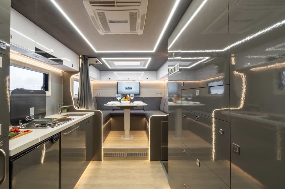 The kitchen area is equipped with a large number of built-in cabinets along the entire wall for convenient storage