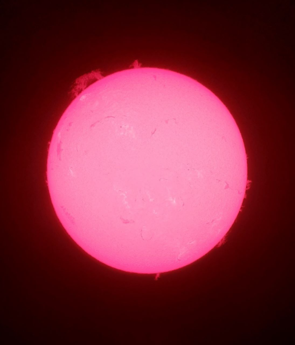 На изображении протуберанец расположен в верхней левой части Солнца