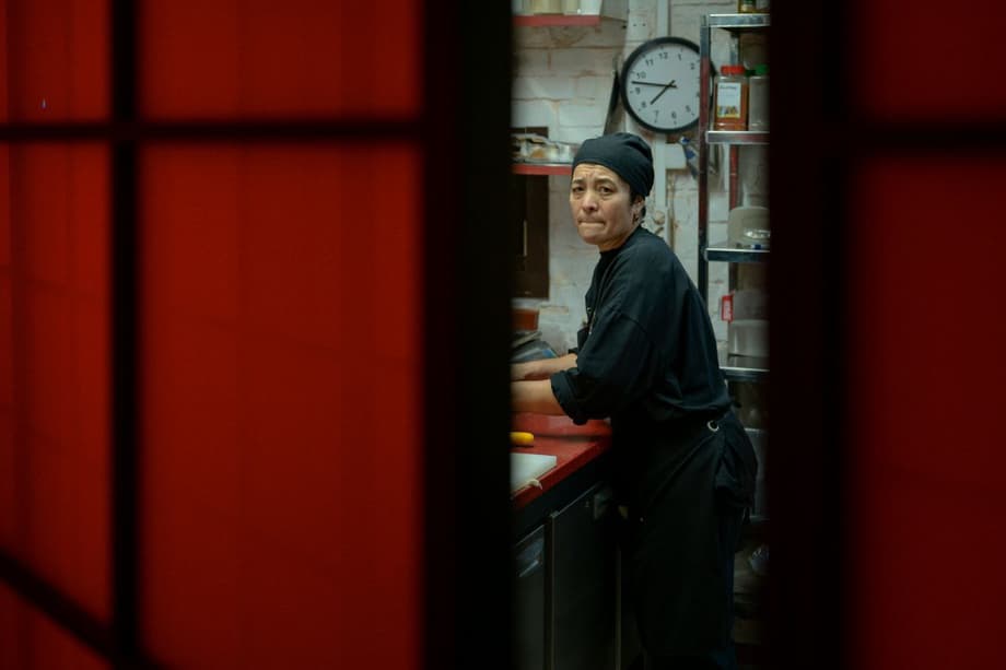 A woman works in the kitchen of a restaurant in Patriarch Ponds